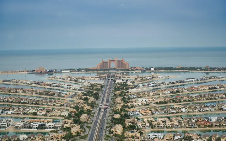 Aerial view of Palm Jumeirah in Dubai with villas along the fronds and the sea beyond
